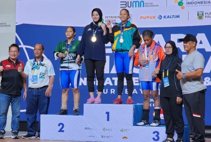 Lifter putri Aceh kelas 59 Kg, Sari Maduma Siregar empat dari kiri (training suit dongker) berpose usai meraih tiga medali emas. Foto : PABSI Aceh.