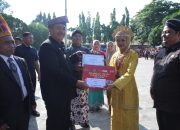 Bupati Gunakan Tanjak Melayu Pimpin Hardiknas di Kabupaten Asahan